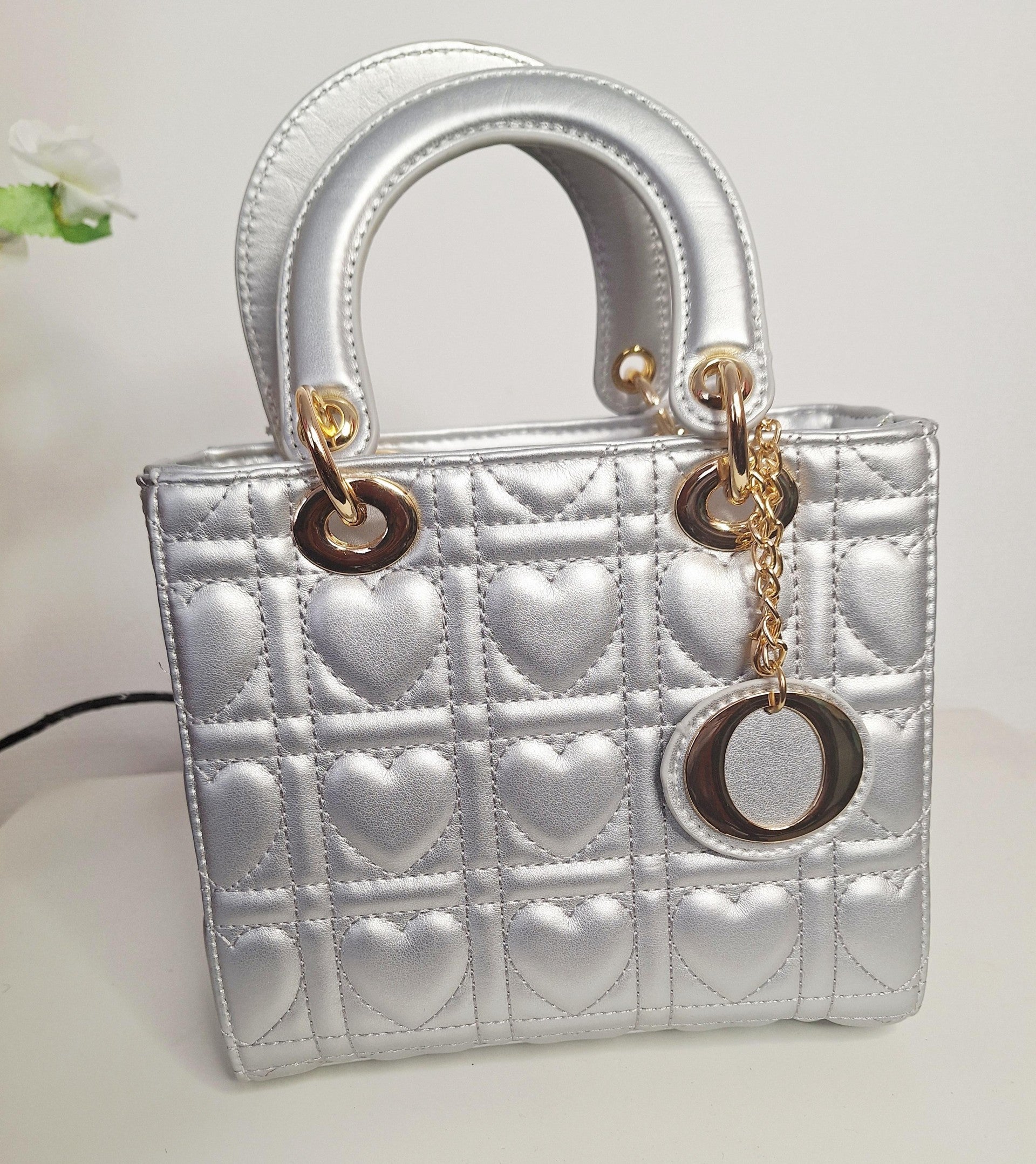 Découvrez notre sac à main carré arge, un accessoire incontournable pour les femmes en quête de style et de fonctionnalité. Son petit format épuré s'adapte parfaitement à vos sorties quotidiennes, tandis que les délicats motifs de petits cœurs brodés ajoutent une touche de romantisme et de personnalité à votre look. Conçu avec soin, ce sac combine élégance intemporelle et praticité. La structure carrée offre un rangement optimal pour vos essentiels – téléphone, portefeuille, clés – sans surcharger votre sil